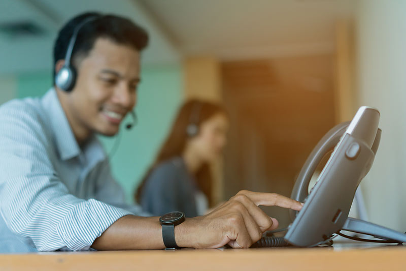 Office employee using VOIP phone system | Open One Solutions Chicago